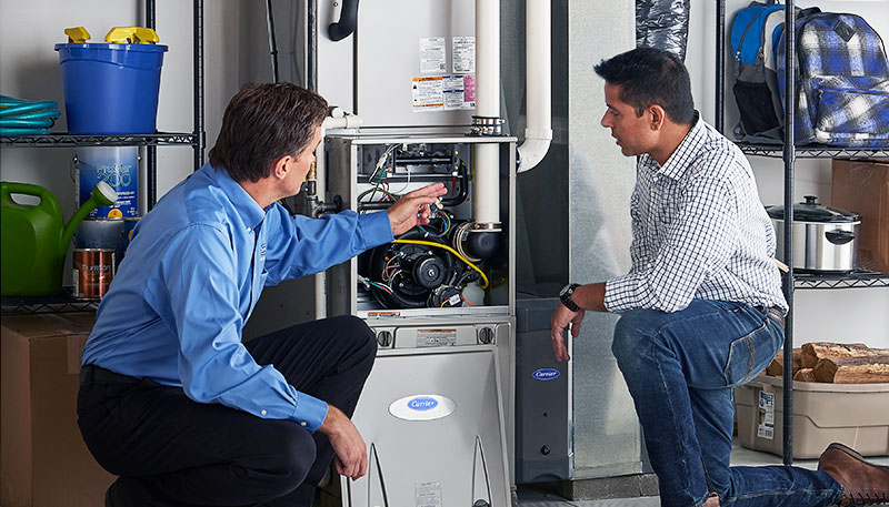 HVAC technician evaluating a furnace for repair or replacement in Englewood
