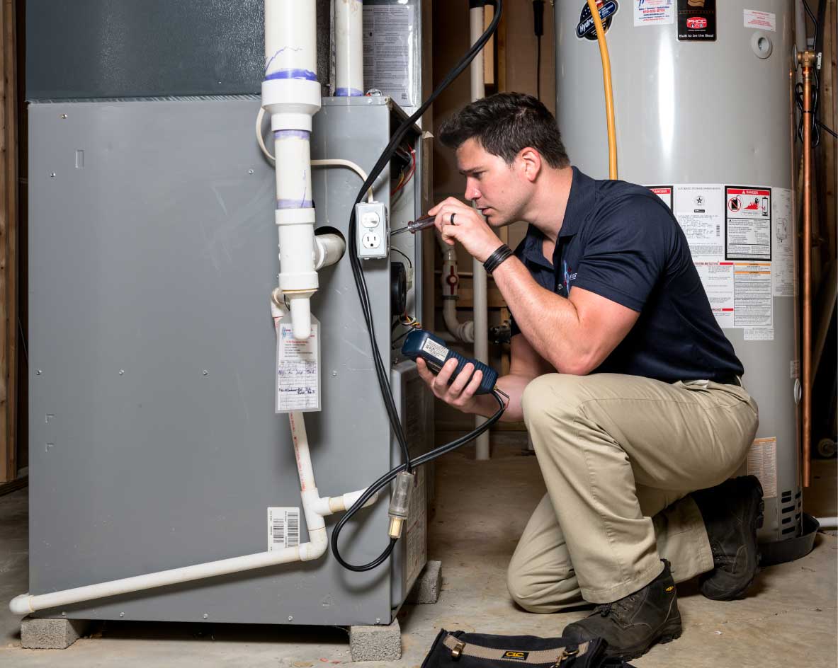 HVAC technician performing a furnace tune-up in Englewood