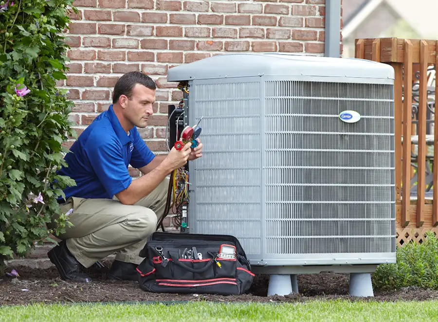 HVAC technician inspecting an outdoor air conditioning unit in Englewood